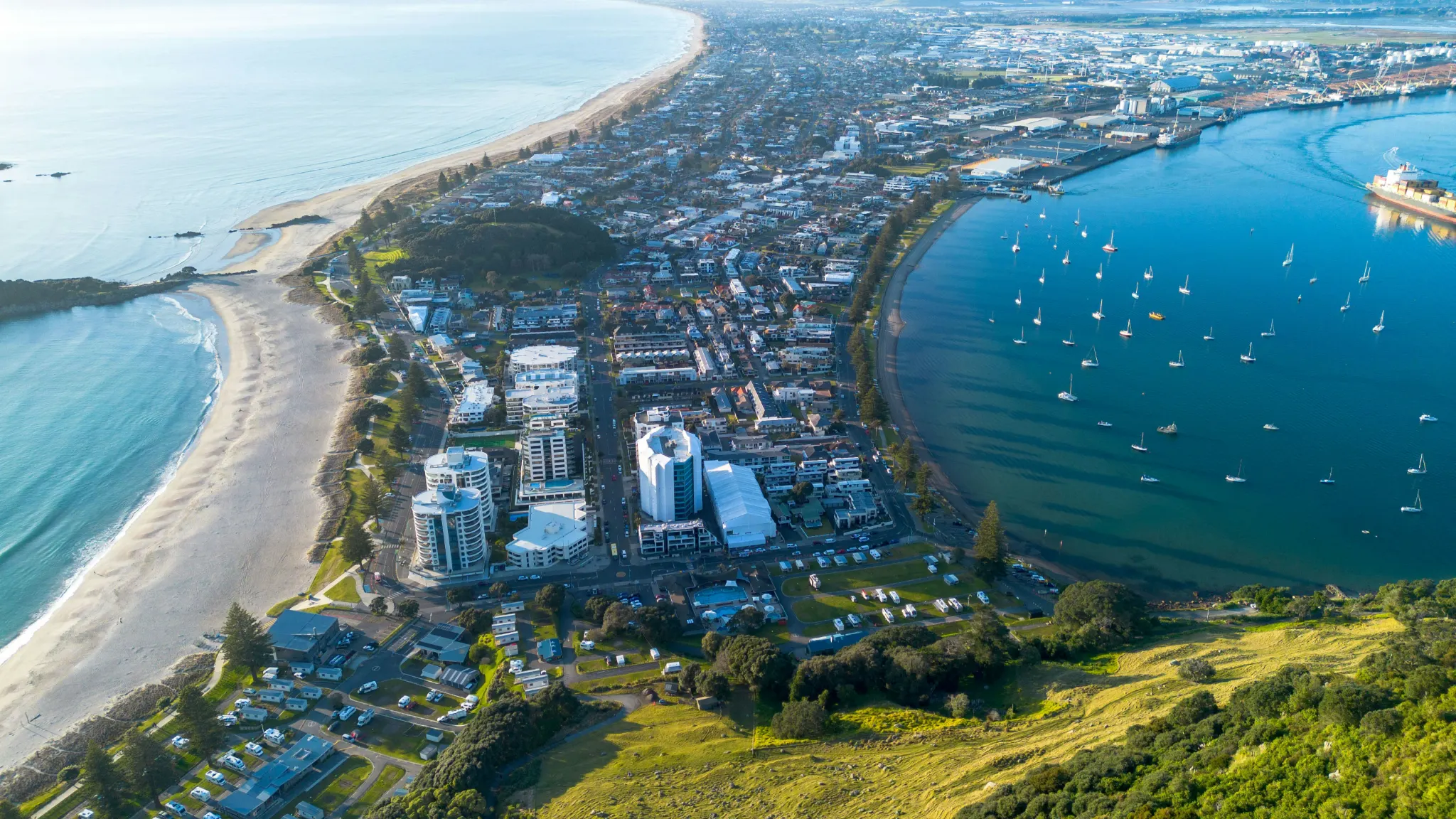 Mount Maunganui, its ocean beach and Tauranga Harbour, seen from the summit of Mauao